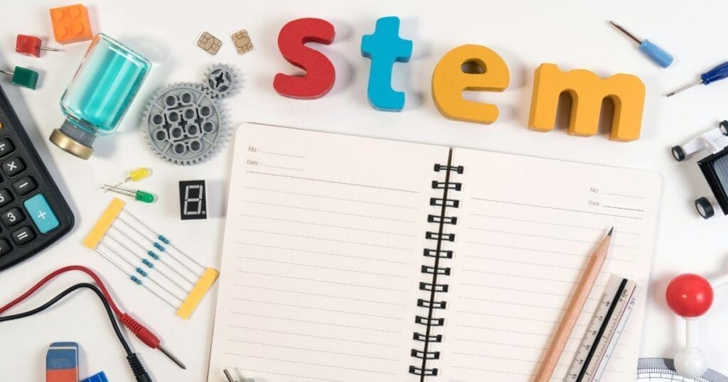 Colorful wooden letters spelling 'listen' above an open notebook with writing tools.