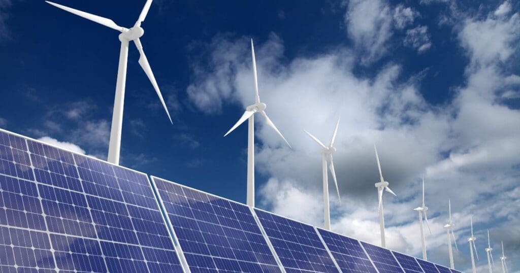 Solar panels and wind turbines producing renewable power to address the clean energy crisis.